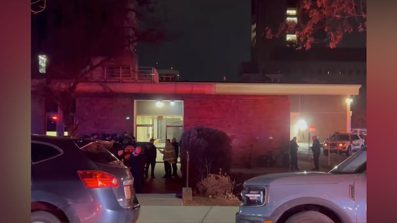 In this image from video, law enforcement officials gather outside the Brown University campus...